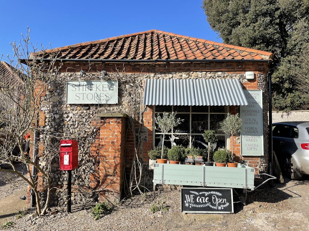 brown brick building with red signage