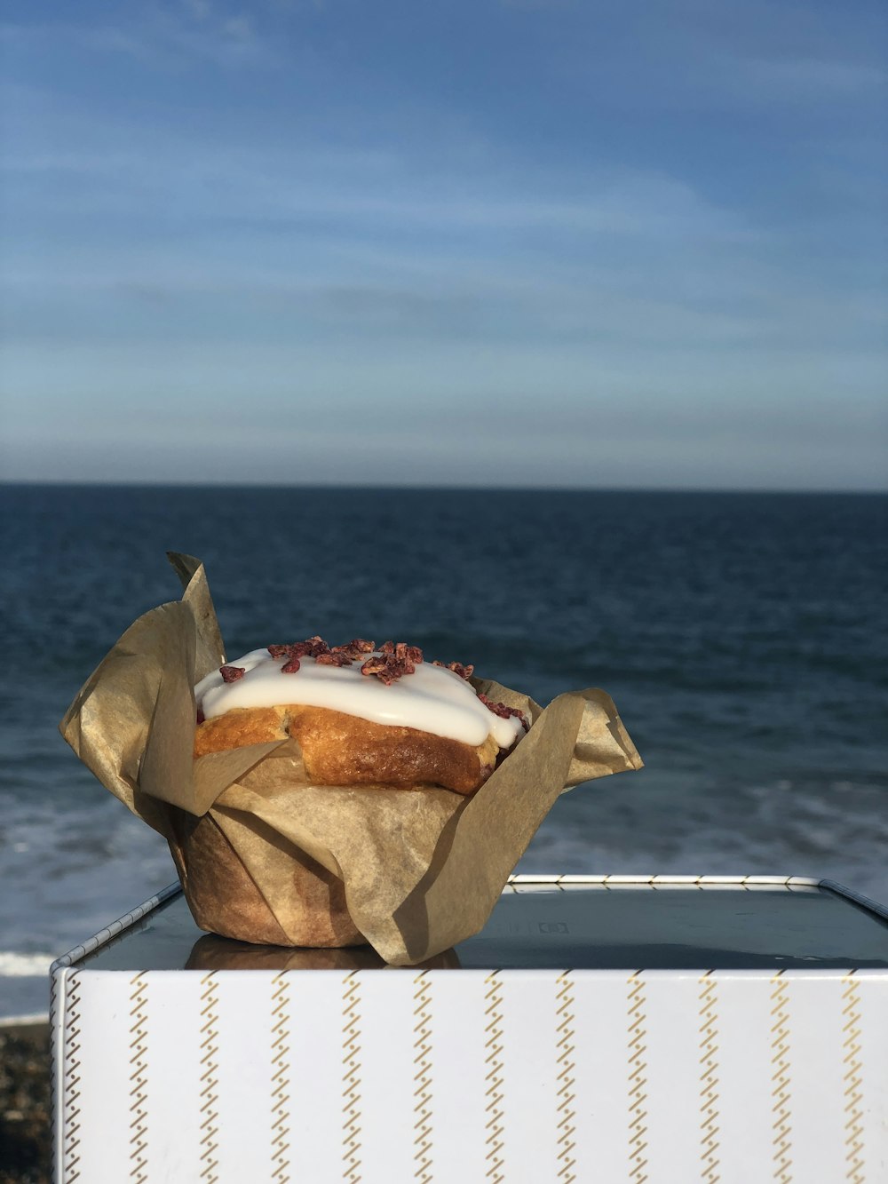 brown bread with red and white cream on white paper