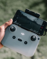 person holding white nintendo switch