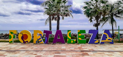 The letters spelling Fortaleza on the Beira Mar promenade, between the palms