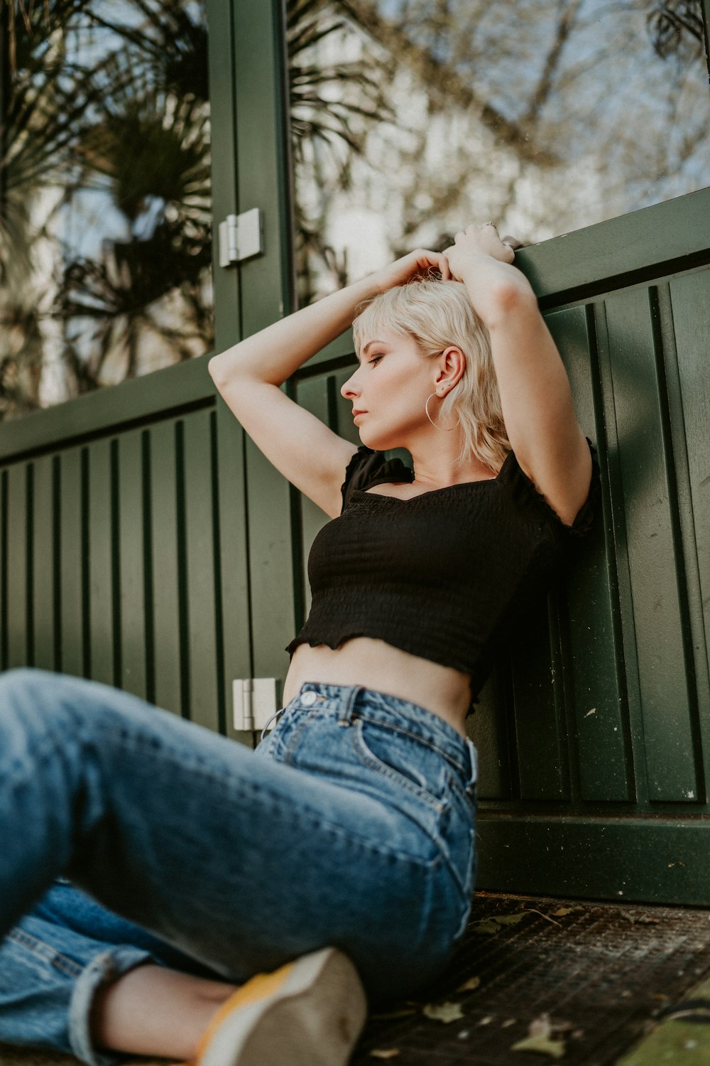 woman in black tank top and blue denim jeans