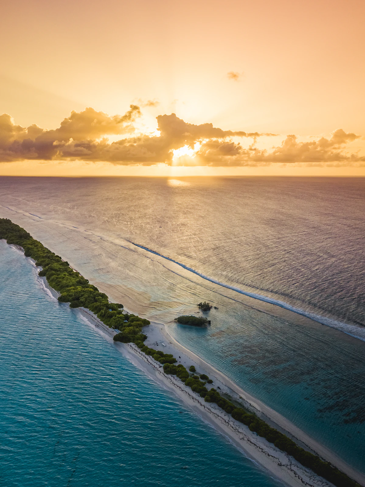 Maldivian atoll at sunset seen from the air