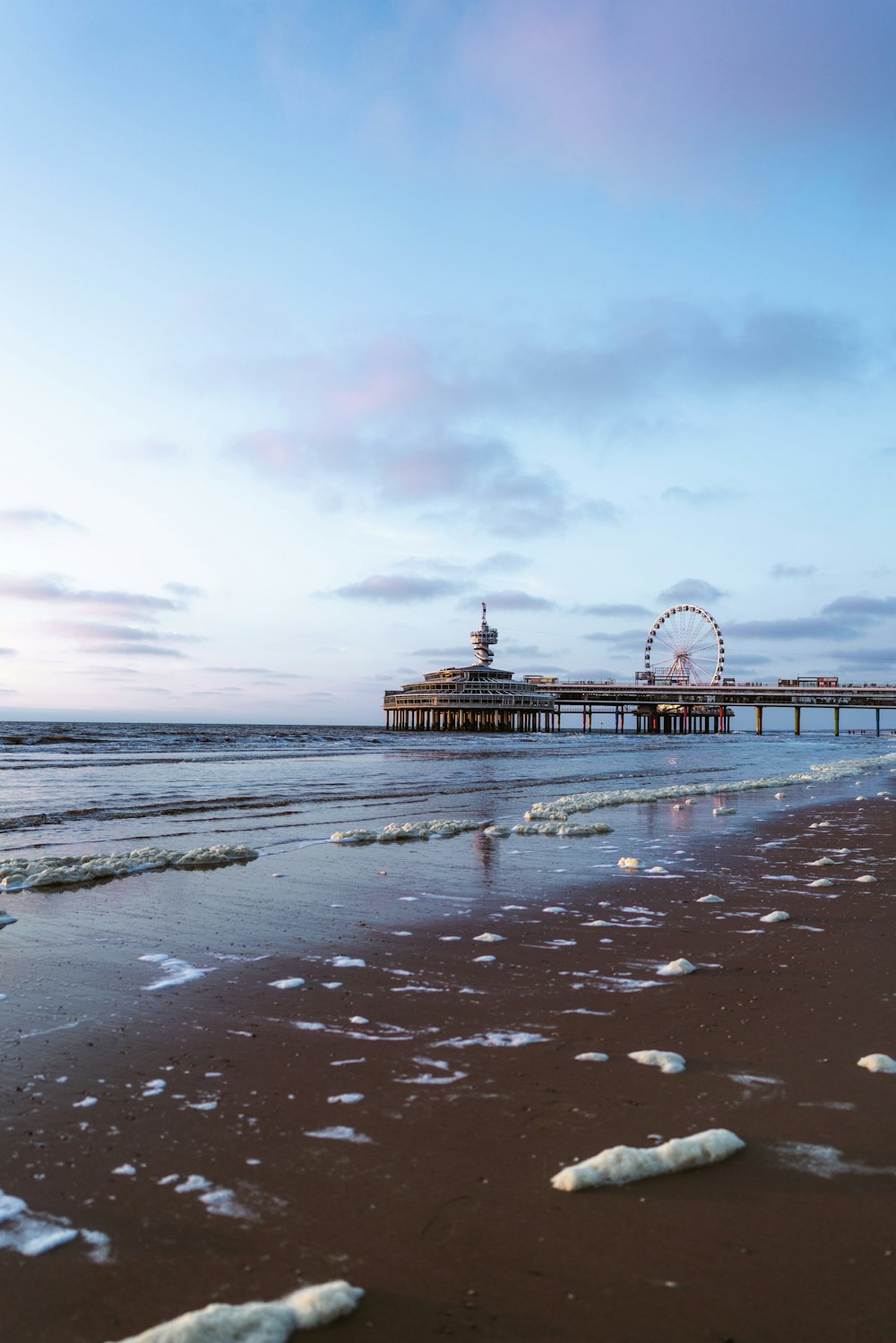 red and white ferris wheel on beach during daytime