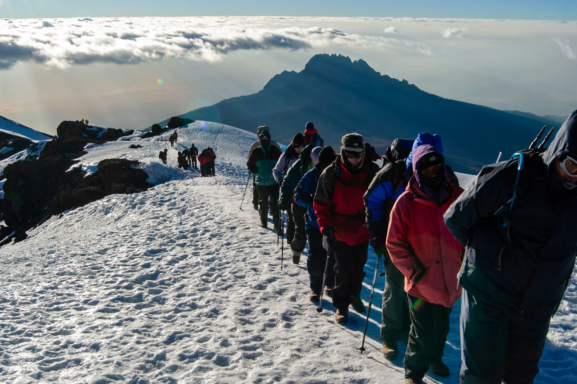 Climbers ascending Mount Kilimanjaro at sunrise