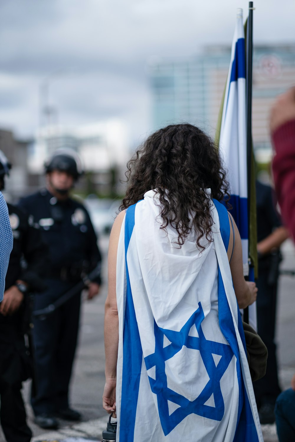 woman in blue and white shirt standing in front of people during daytime