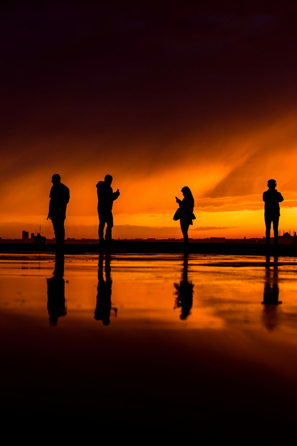 silhouette of 2 person standing on beach during sunset