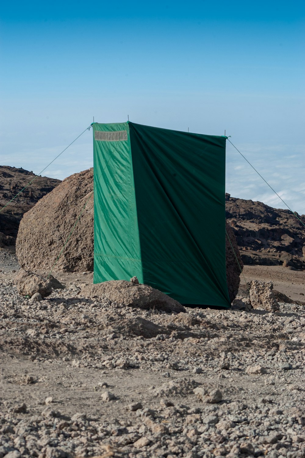 green tent on brown soil