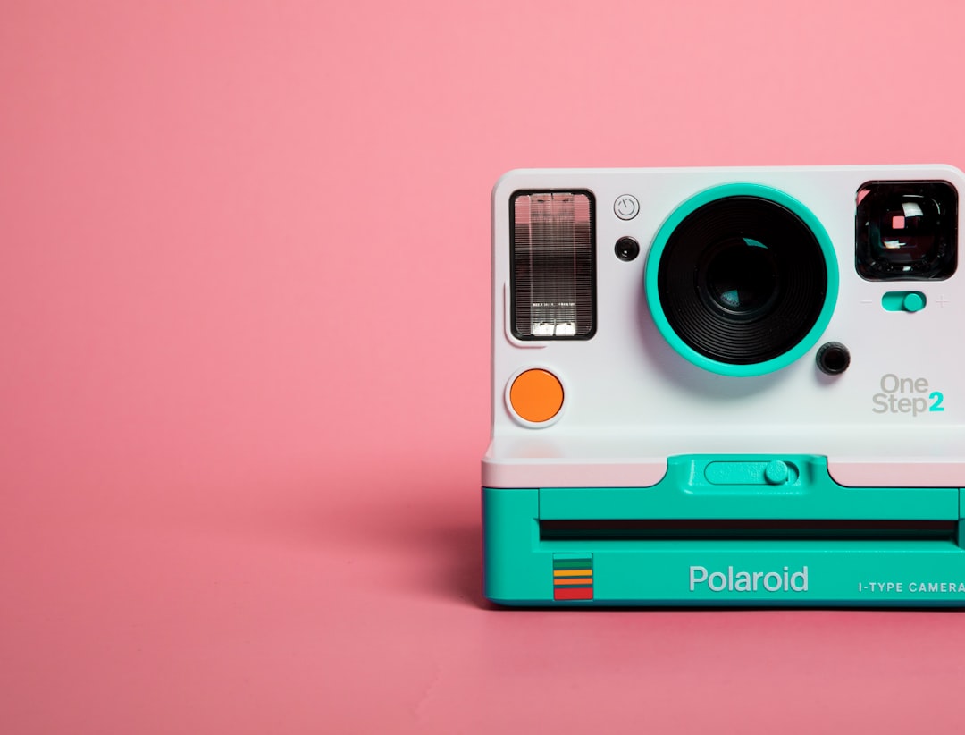 teal and white polaroid camera