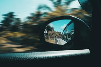 car side mirror with a reflection of sun