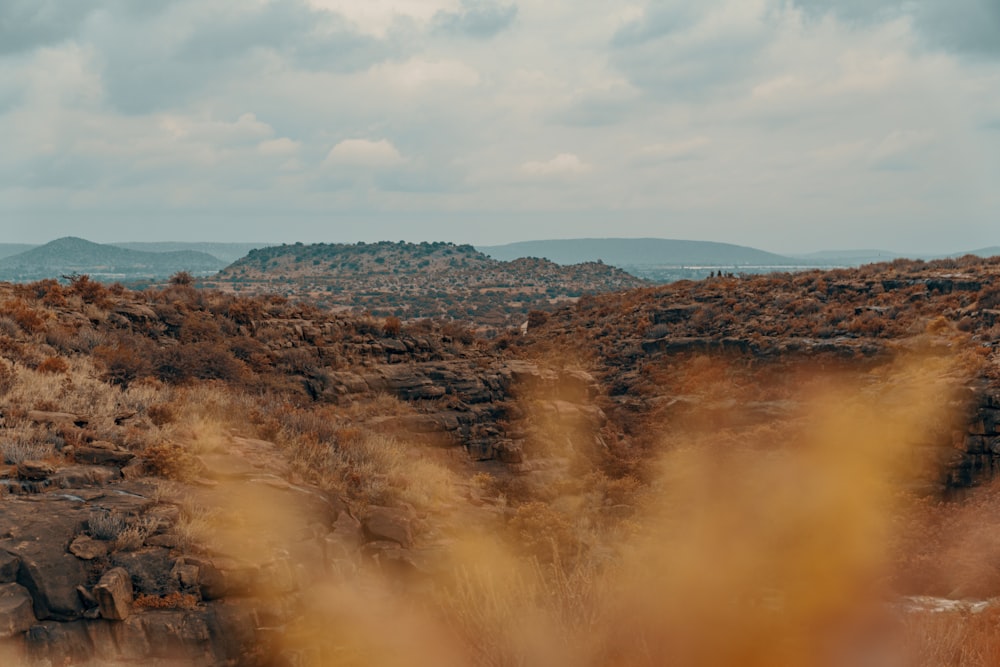 brown and green mountains under white clouds during daytime