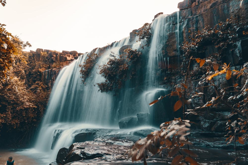 brown and gray rock formation with water falls