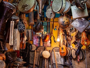 brown wooden guitar hanging on wall