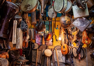 brown wooden guitar hanging on wall