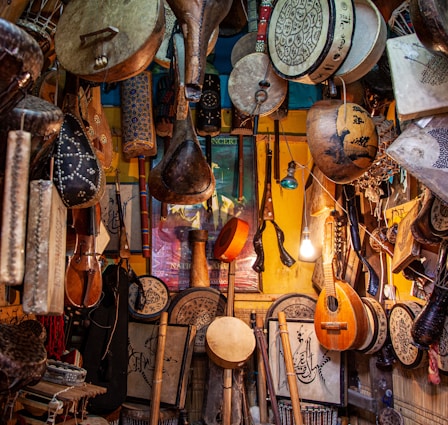 brown wooden guitar hanging on wall