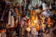 brown wooden guitar hanging on wall