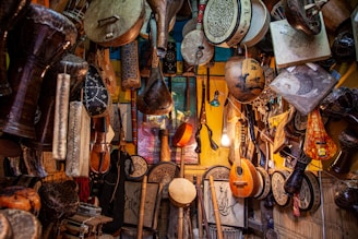 brown wooden guitar hanging on wall