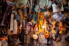 brown wooden guitar hanging on wall