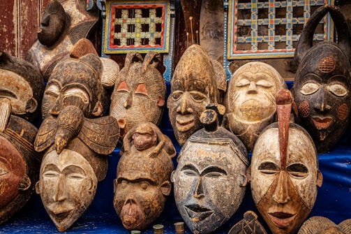 brown wooden mask on blue textile
