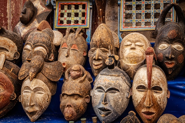 brown wooden mask on blue textile