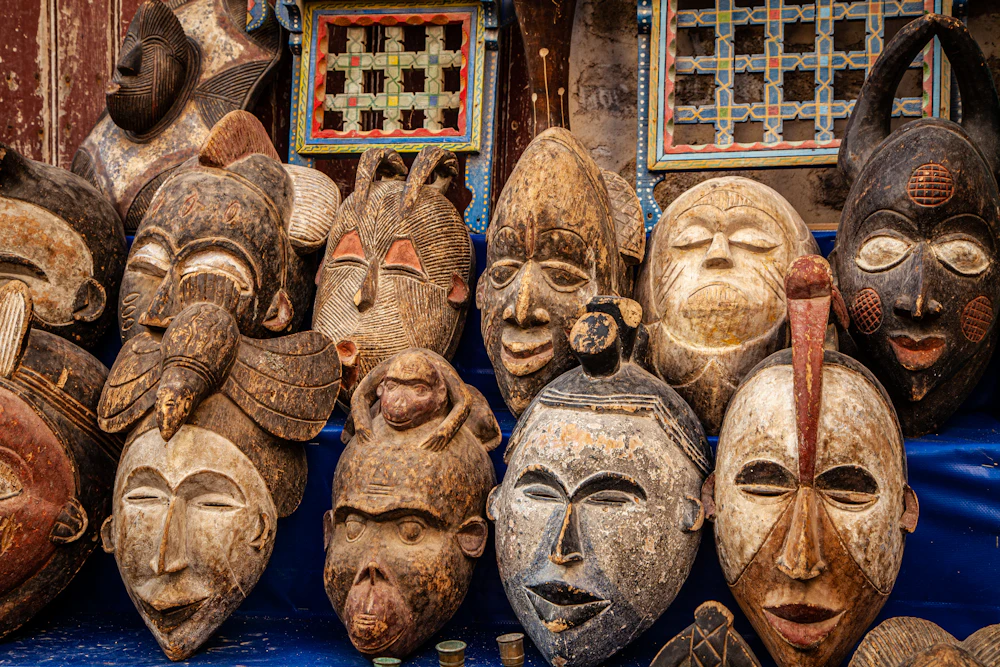 Brown wooden mask displayed on blue textile