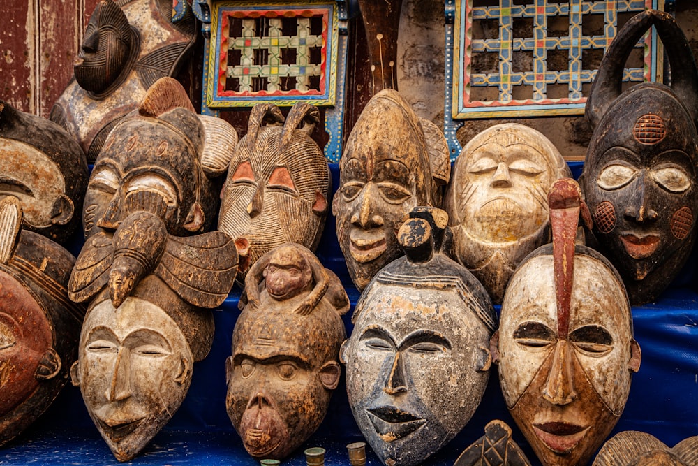 brown wooden mask on blue textile