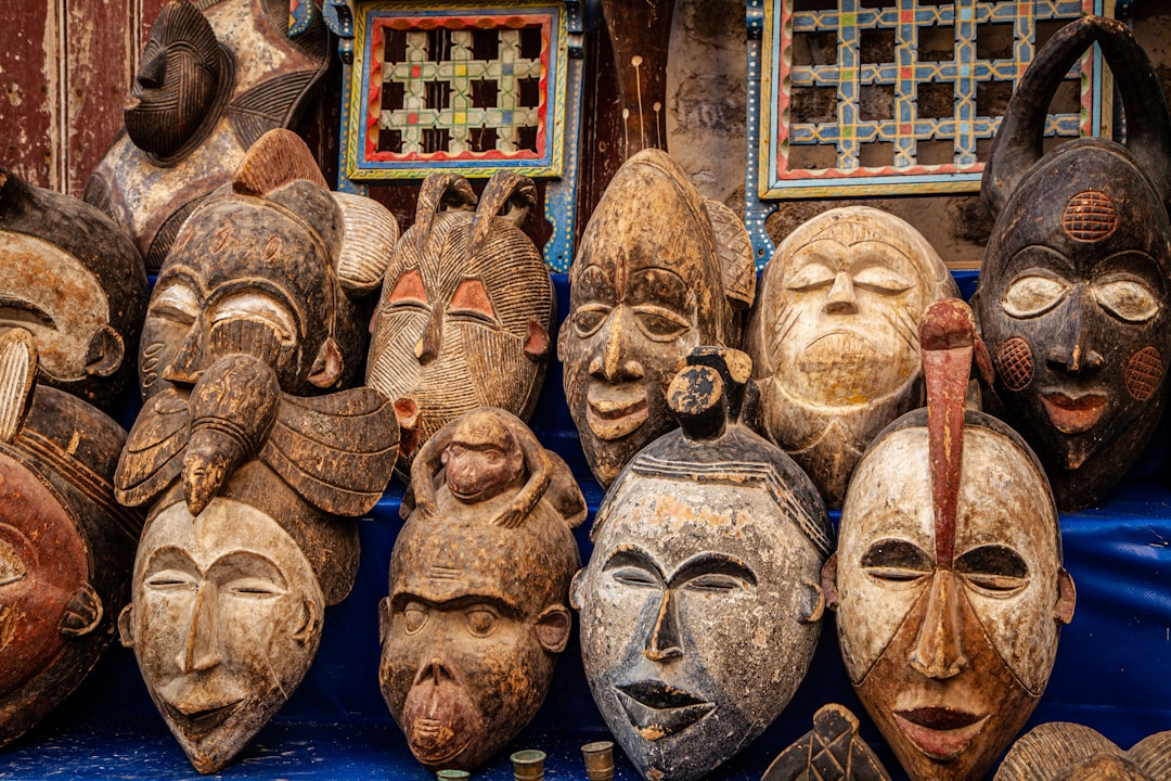 brown wooden mask on blue textile,