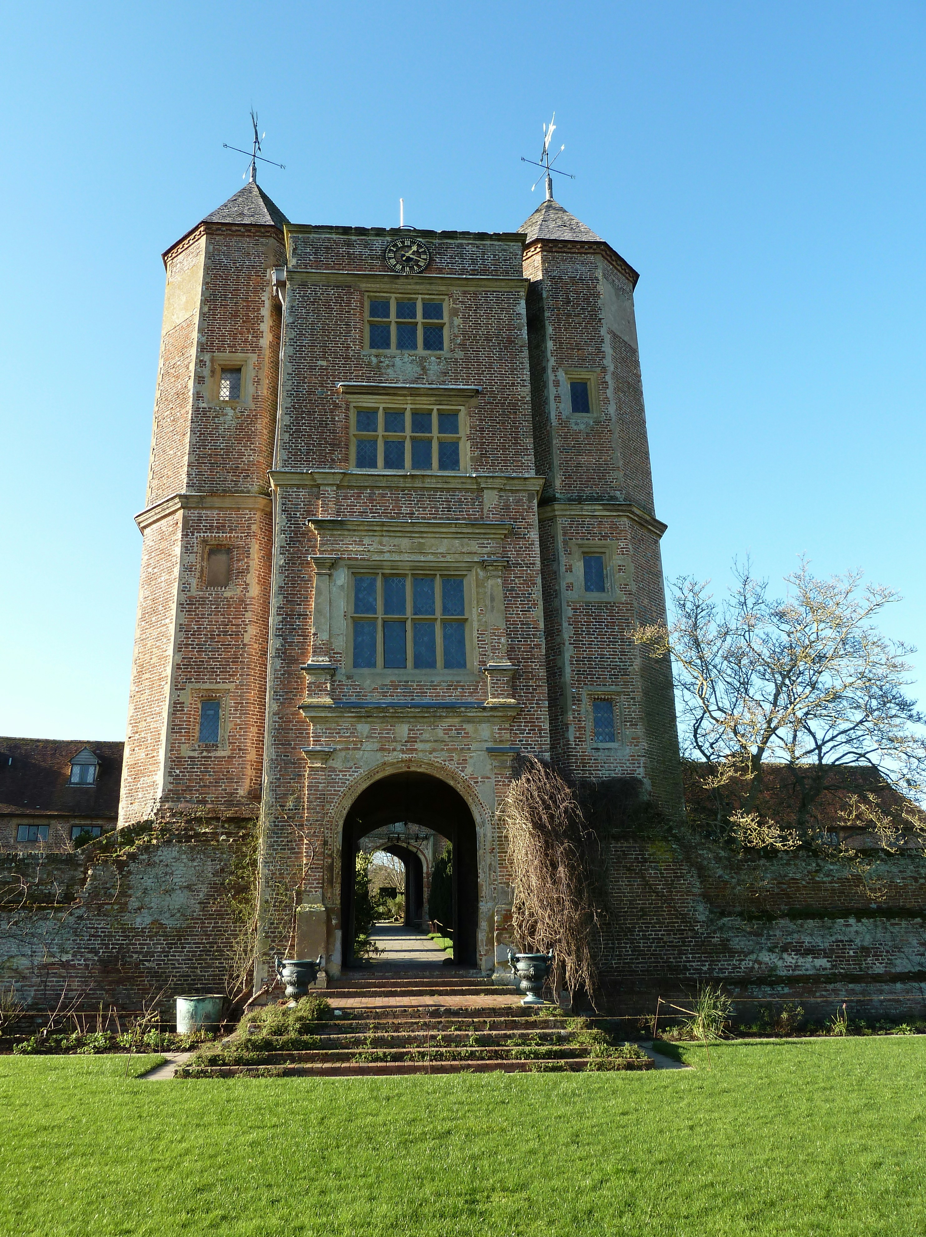brown brick building near green grass field during daytime