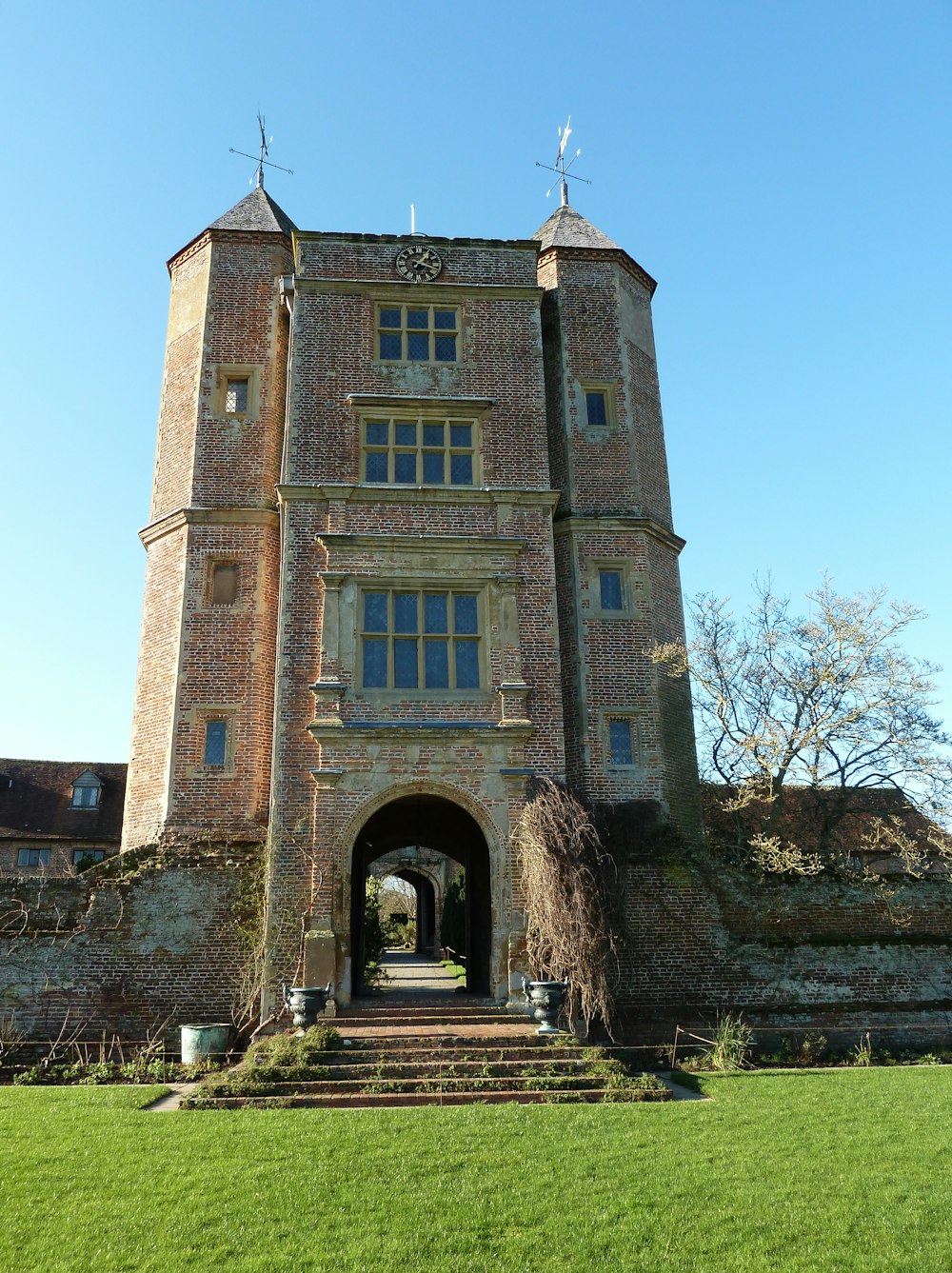 brown brick building near green grass field during daytime