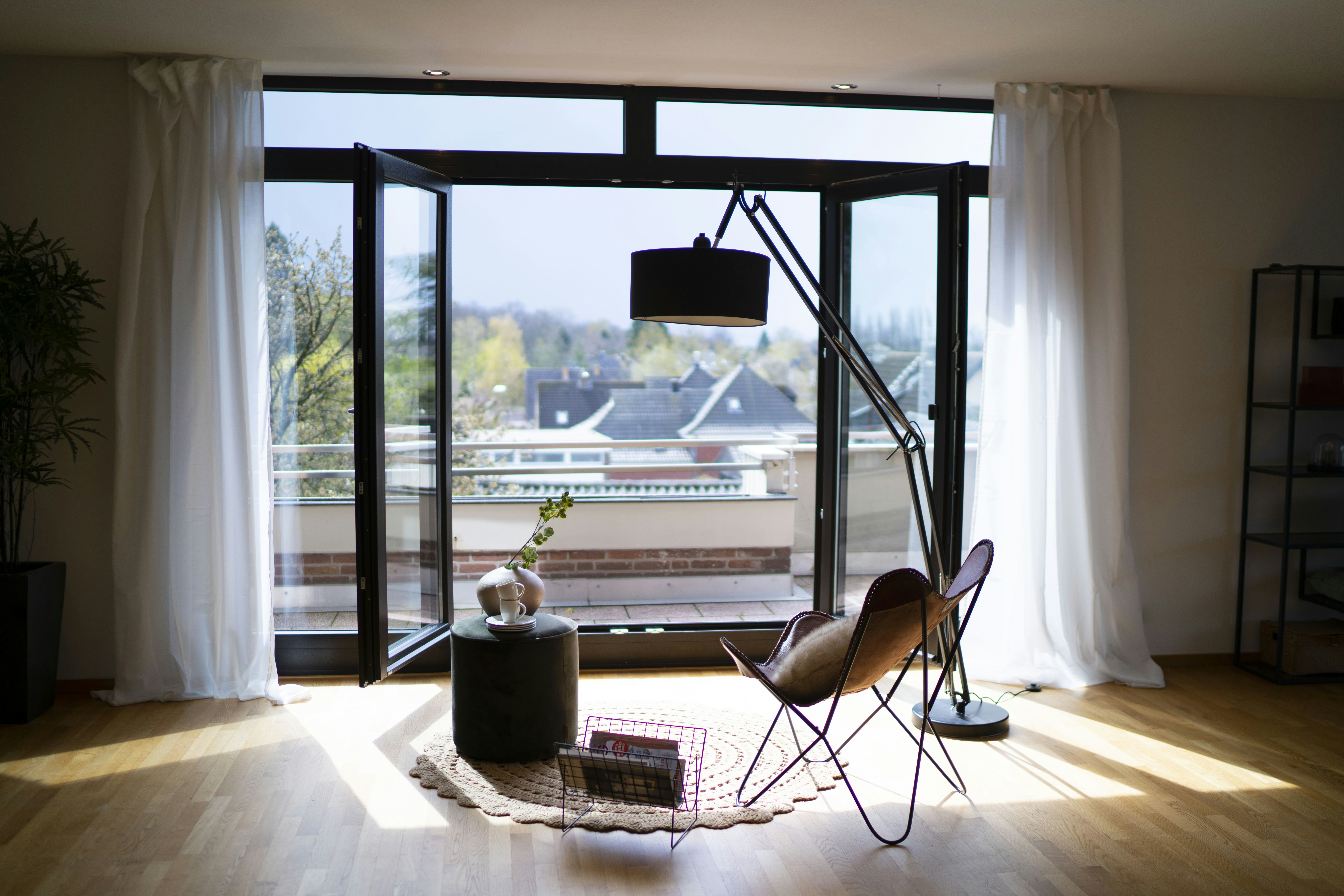 black metal framed brown padded chair near window