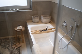 white ceramic bathtub near white ceramic bathtub
