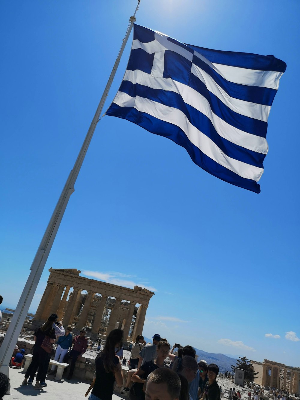 blue and white striped flag on pole