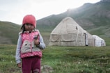 An artistic shot of an Uzbek girl surrounded by colorful flowers.