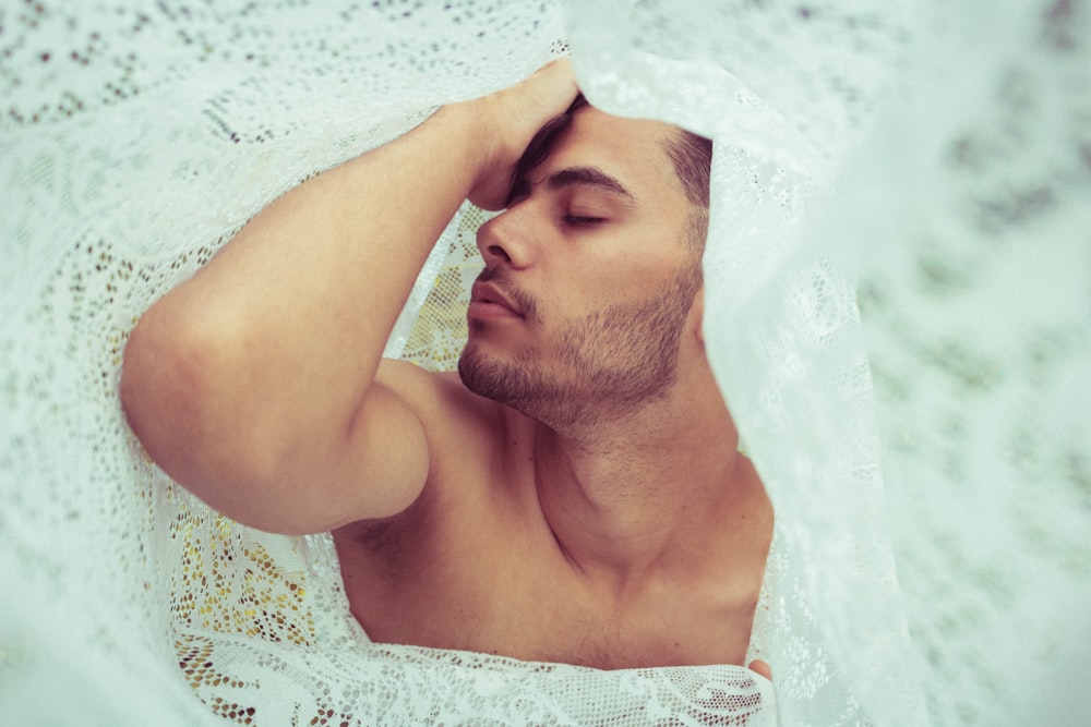 man in white floral dress on white sand