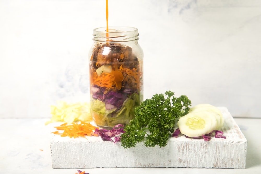 clear glass jar with yellow and white liquid