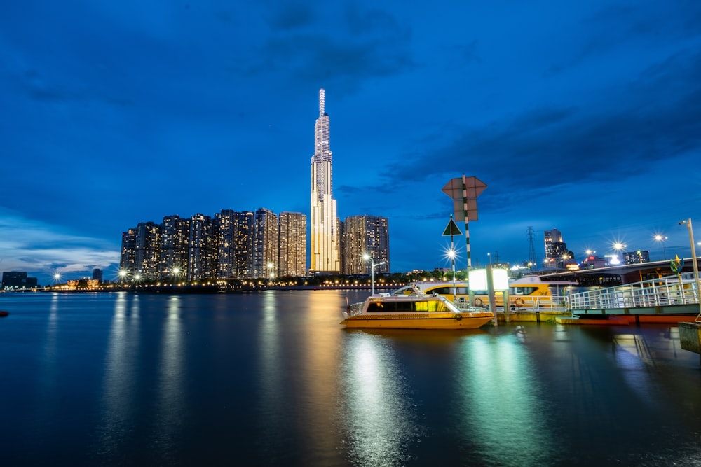 city skyline across body of water during night time