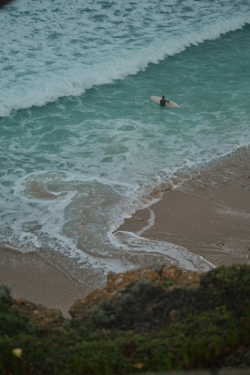 person surfing on sea waves during daytime