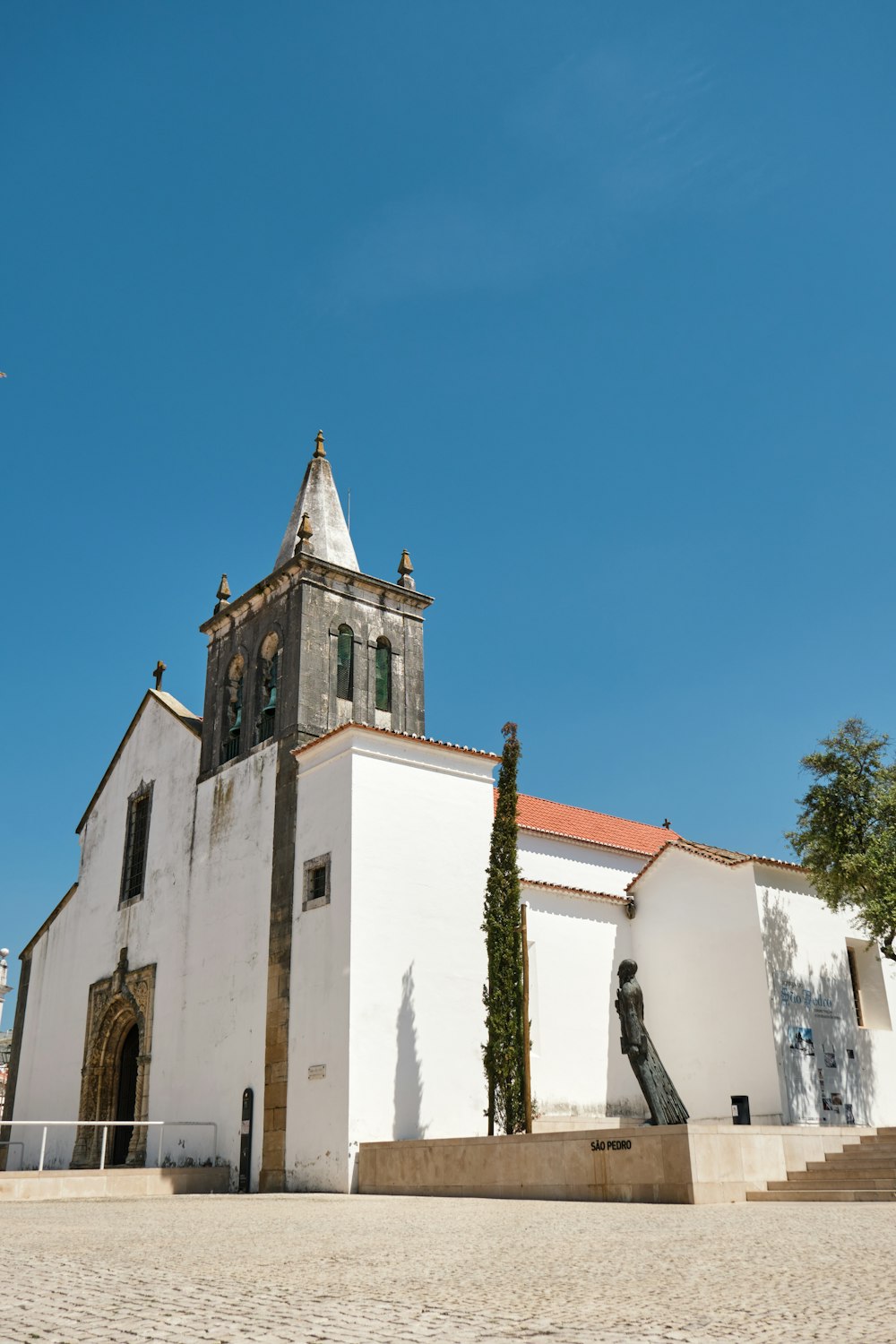 white and brown concrete church under blue sky during daytime