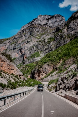 black car on road near mountain during daytime