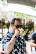 man in black and white floral shirt wearing black sunglasses