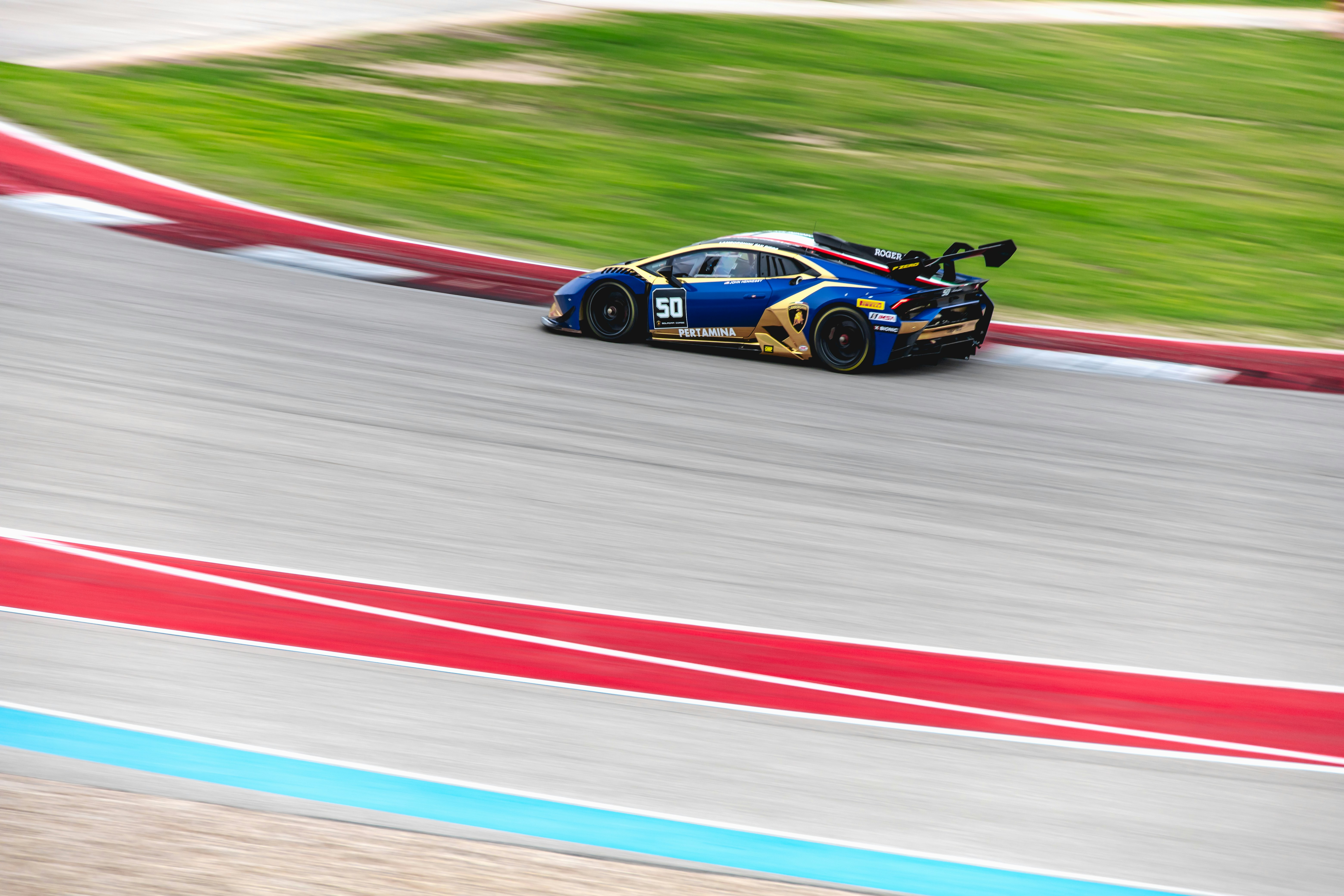 black and red race car on track