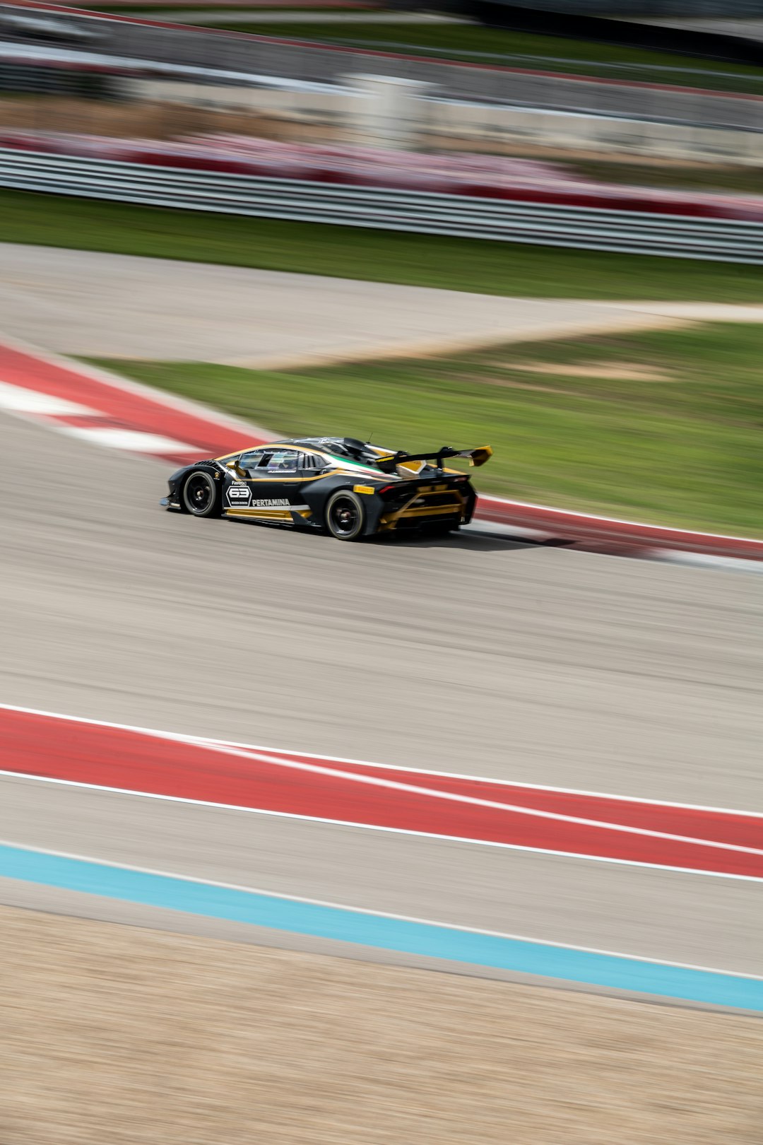 black and yellow sports car on track