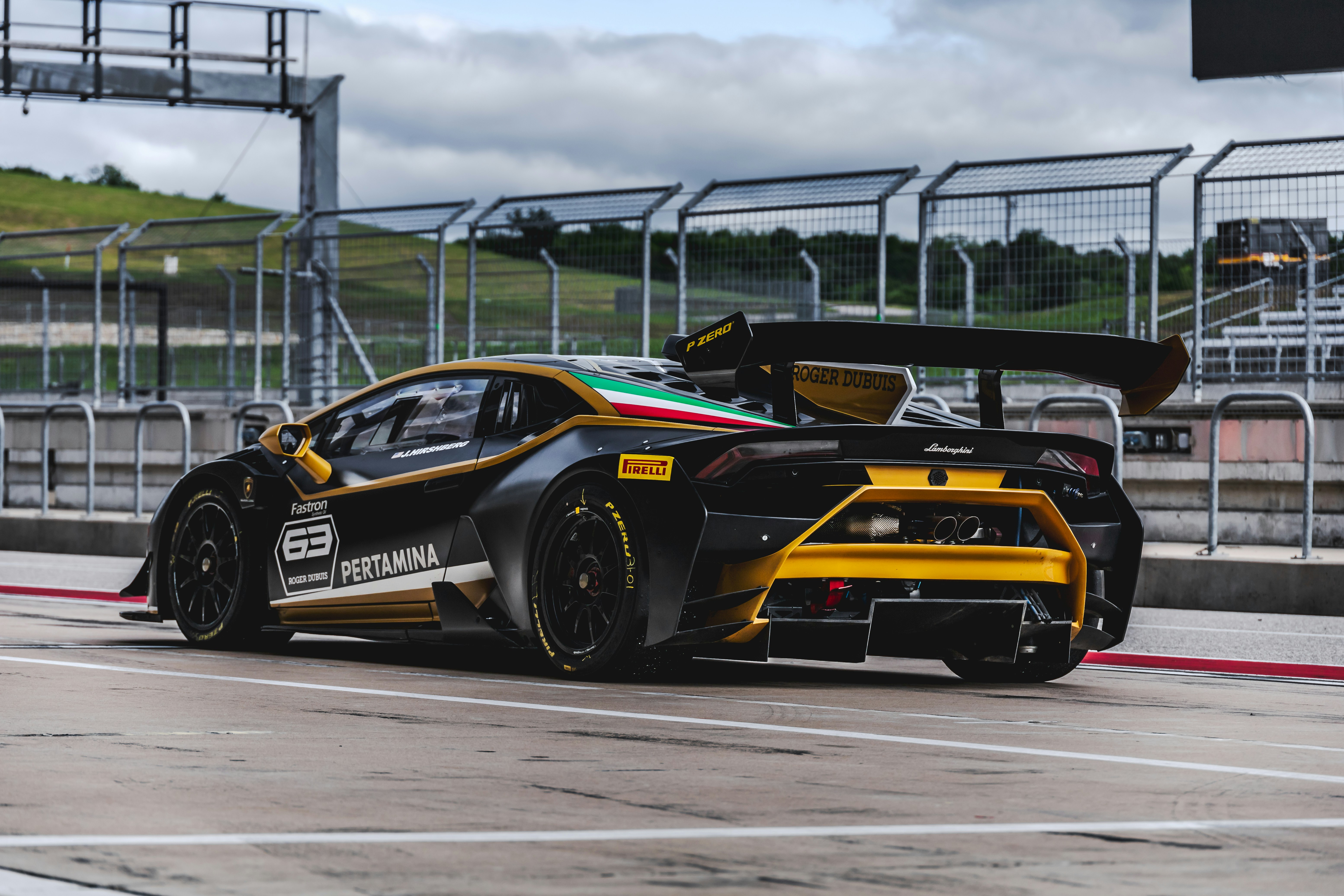 orange and black porsche 911 on road during daytime