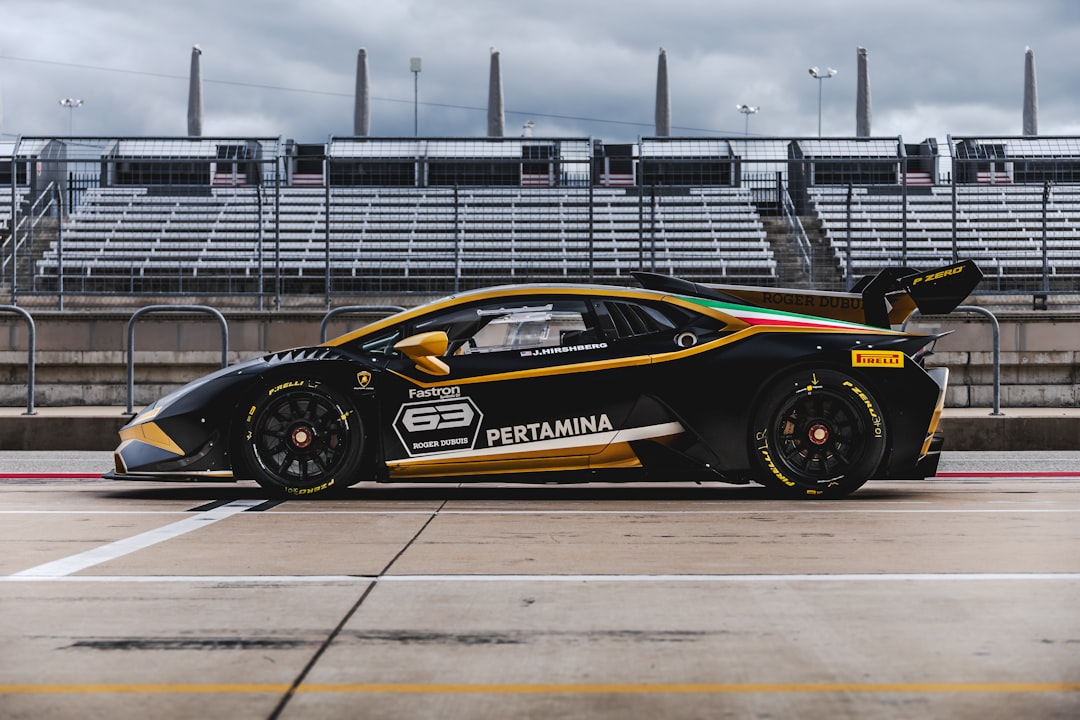 black and yellow porsche 911 on gray road