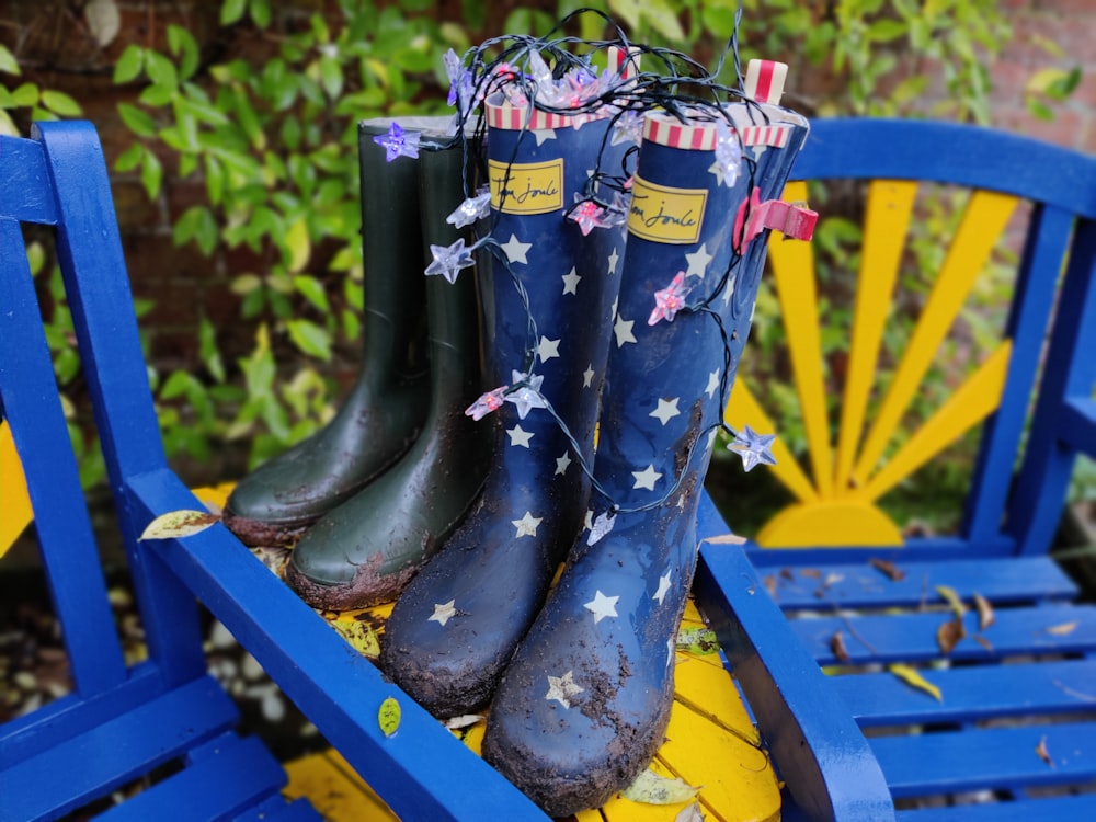 brown and black rain boots on blue wooden bench