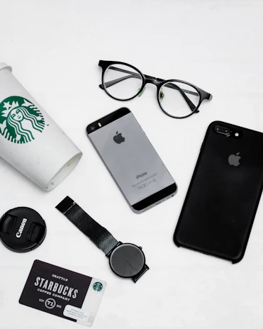 Flat lay of starstory accessories including minimalist black caps and soft purple gradient scarves on a clean white surface.
