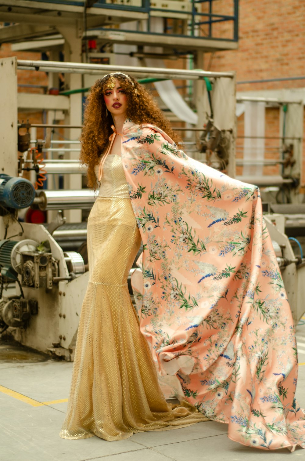 woman in white and pink floral dress standing near motorcycle during daytime