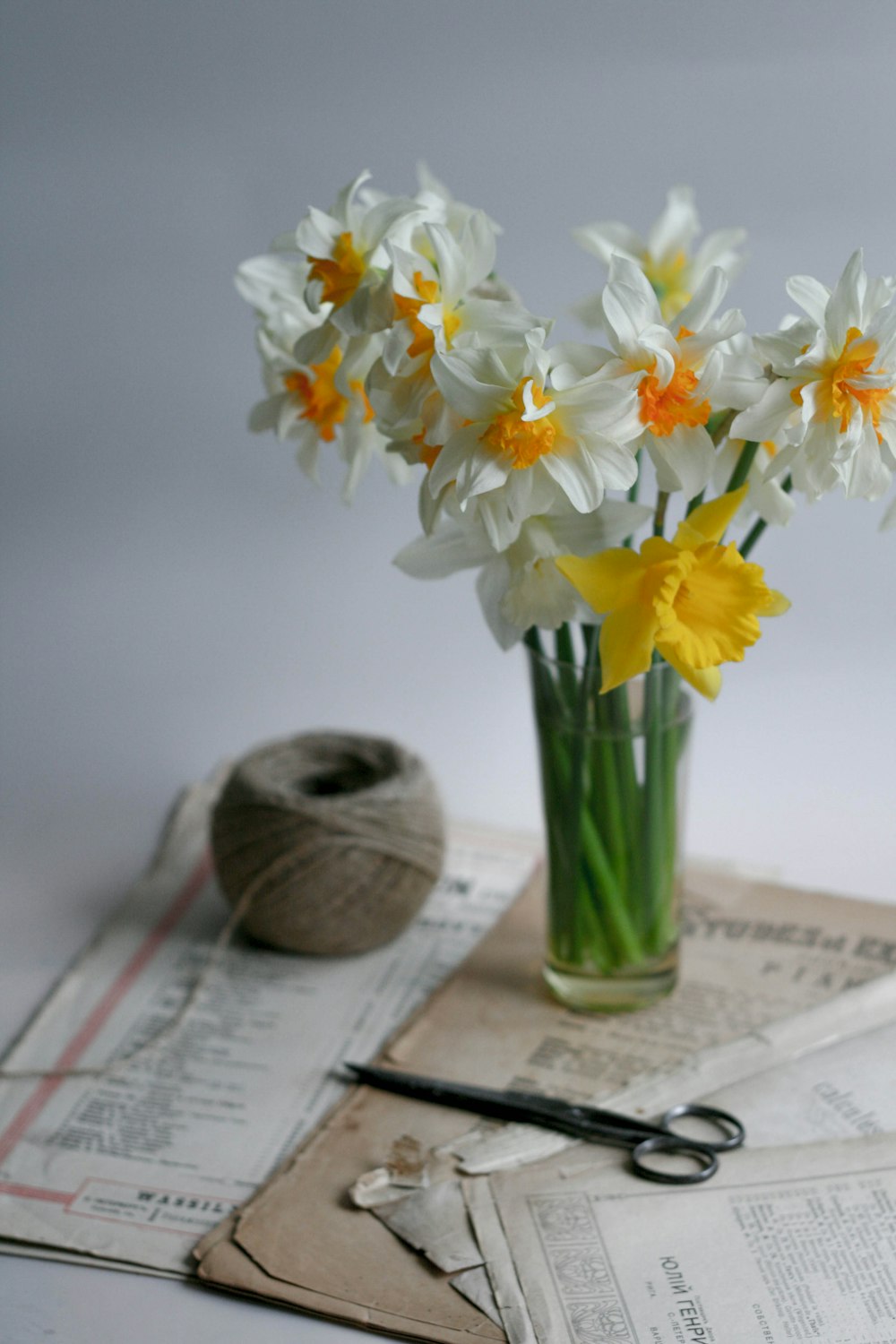 white and yellow flowers in clear glass vase