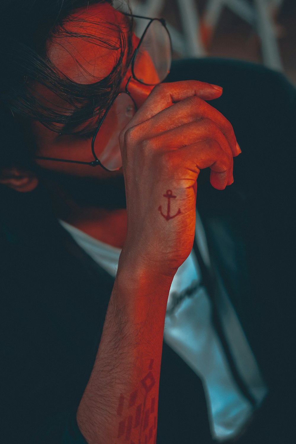 woman in white shirt covering her face with her hand