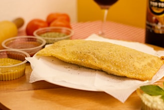 bread on white paper towel beside red wine glass