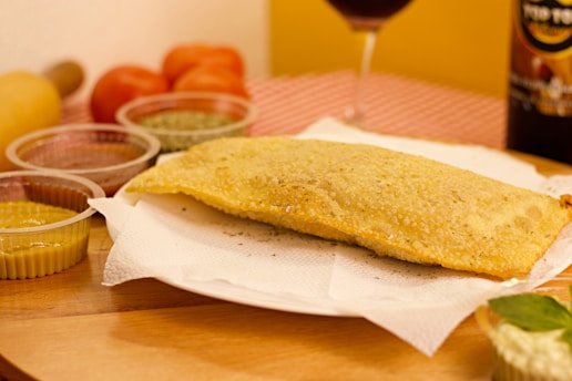 bread on white paper towel beside red wine glass